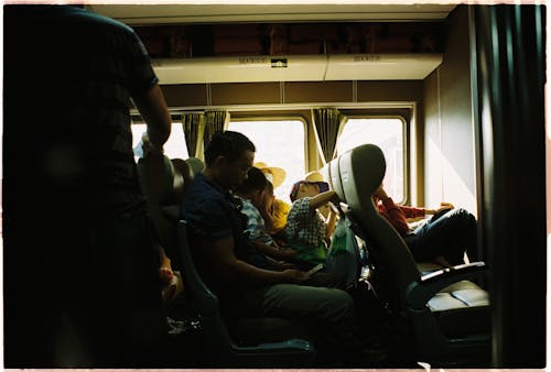 Commuters Sitting on the Seat of a Bus