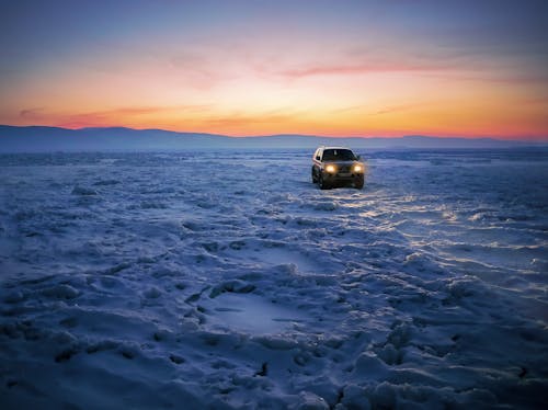 Free Black Suv on Snow during Golden Hour Stock Photo