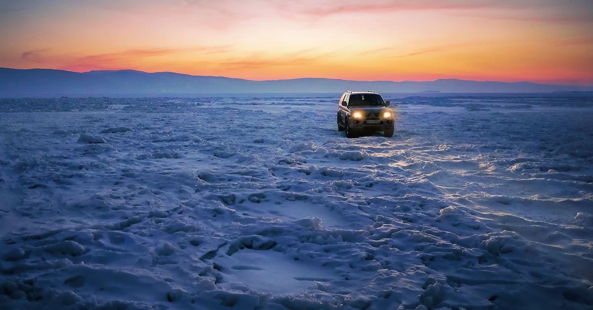 Black Suv on Snow during Golden Hour