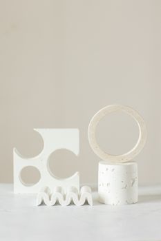Abstract geometric shapes elegantly arranged on a minimalist backdrop.