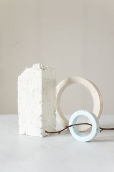 A minimalist composition featuring geometric shapes and a twig, exhibiting simplicity and balance.