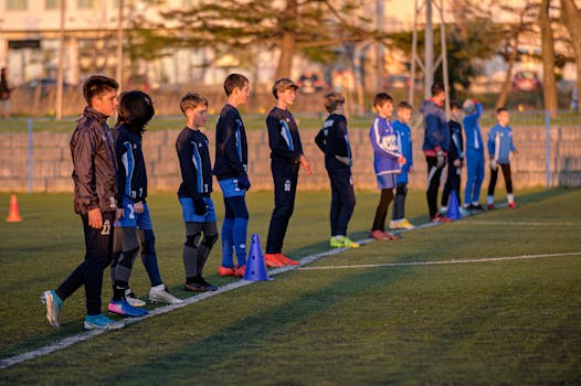 Young soccer team standing in a line during practice session outdoors.