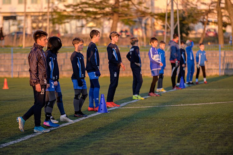 Photo Of Kids In Football Uniform Standing In A Line