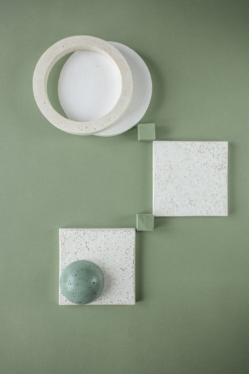 Ceramic Squares, Circles and a Bead on Green Background