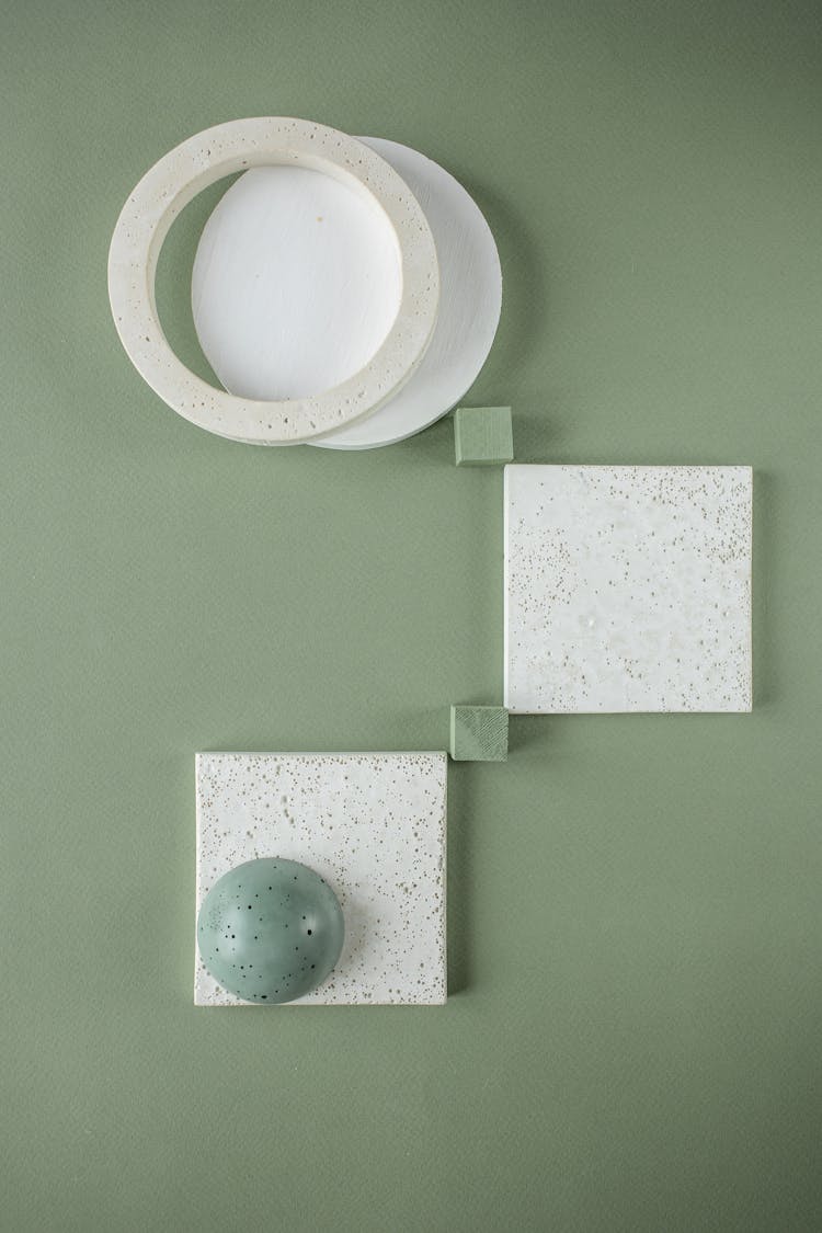 Ceramic Squares, Circles And A Bead On Green Background