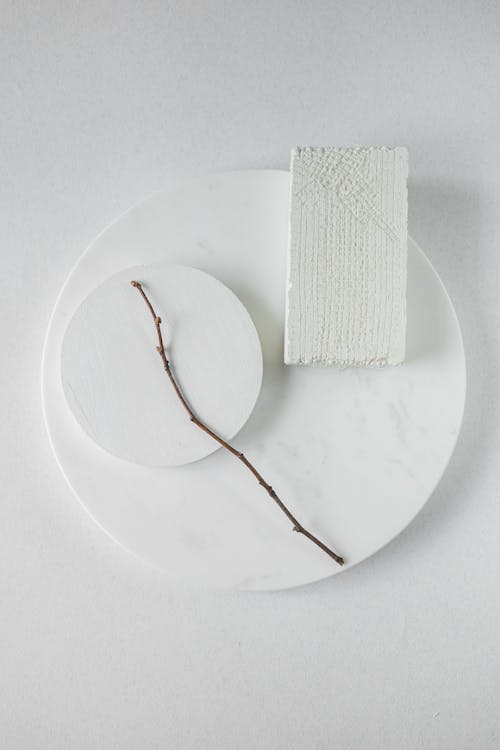 A Stick Lying on White Plates 