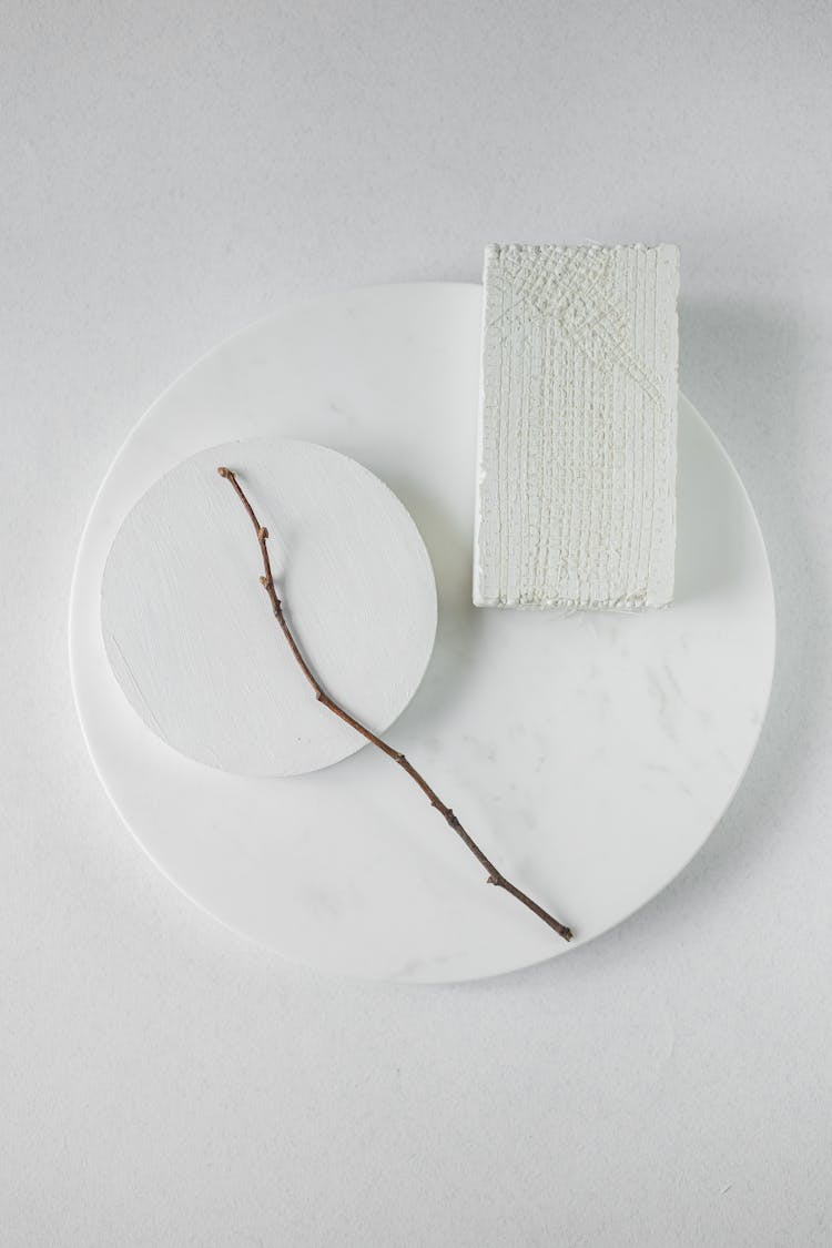 A Stick Lying On White Plates 