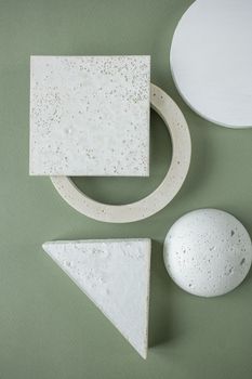 Minimalist abstract art featuring geometric shapes on a green background, highlighting texture and form.