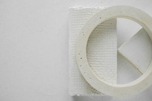 Close-up of textured white plaster shapes with geometric patterns, offering creative design potential.