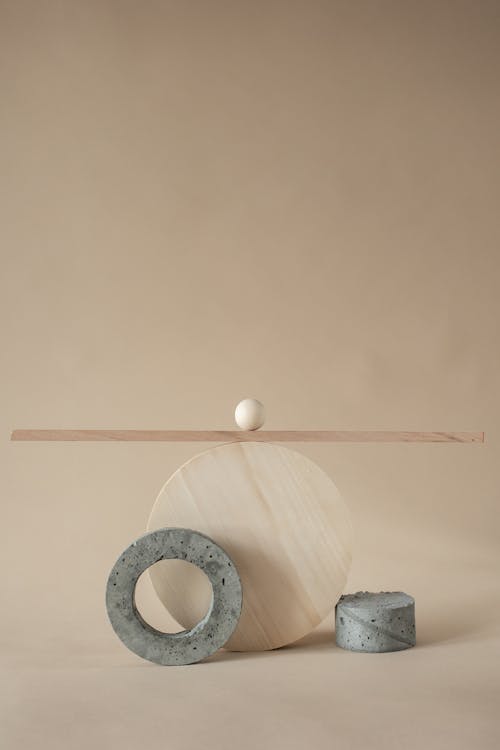 Studio Shoot of Simple Concrete and Wooden Shapes against Beige Background