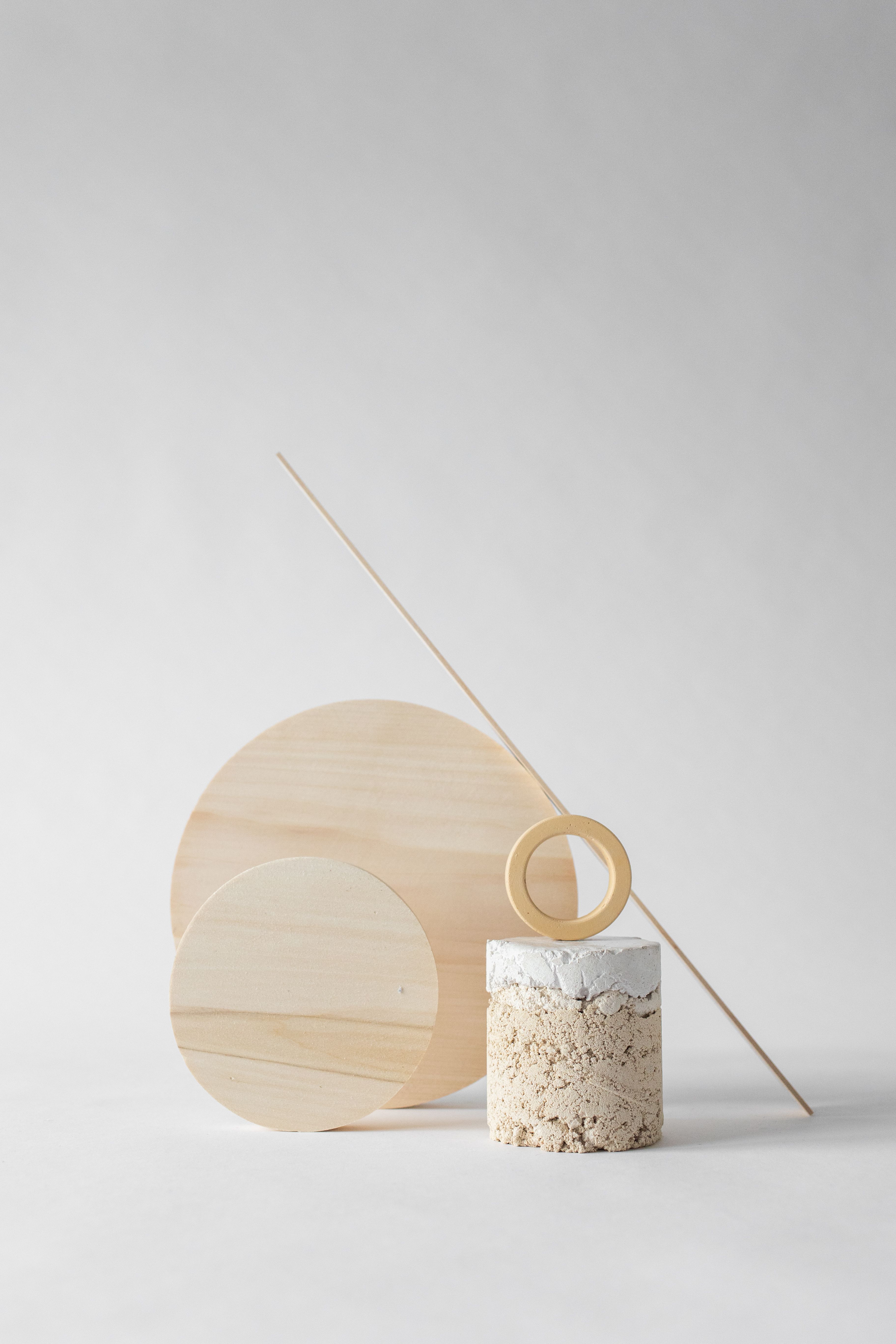 A minimalist still life arrangement of wooden and concrete shapes, perfect for modern decor.