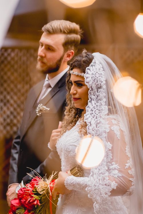 Free Beautiful portrait of a Brazilian bride and groom in elegant wedding attire. Stock Photo