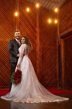 A beautiful couple posing on their wedding day in an elegant venue in Brazil.