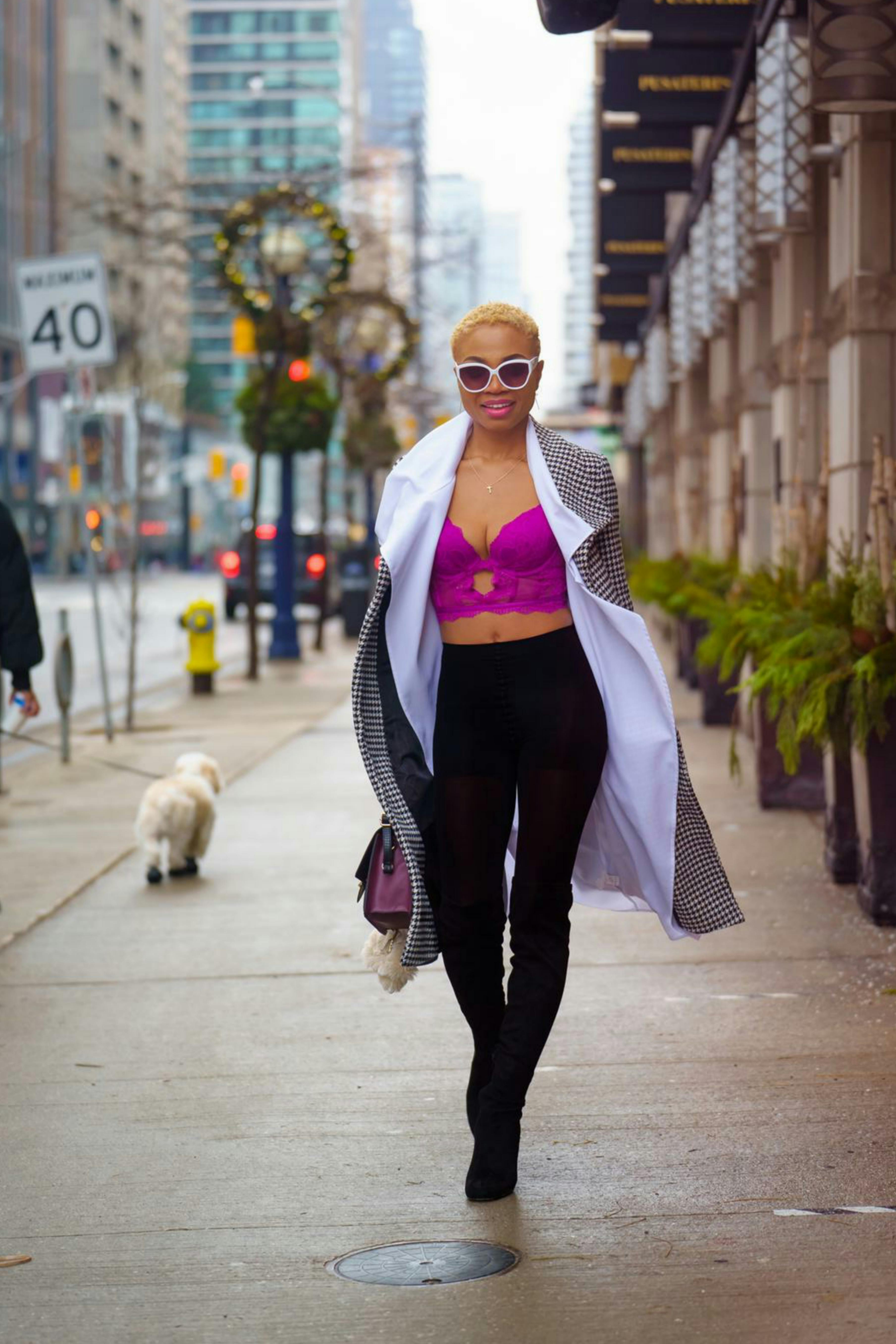 stylish woman walking on sidewalk