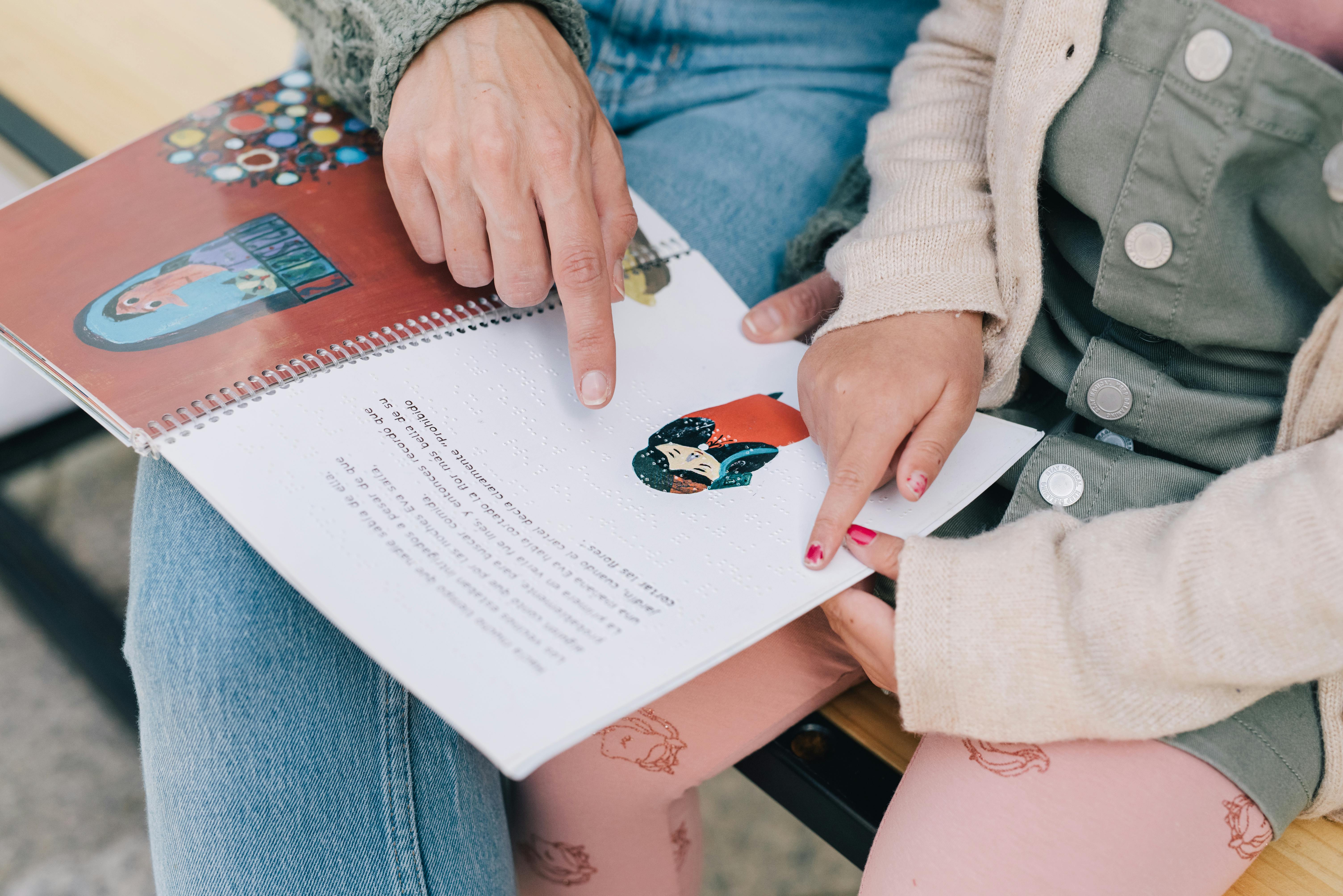 mother and daughter reading a story in braille