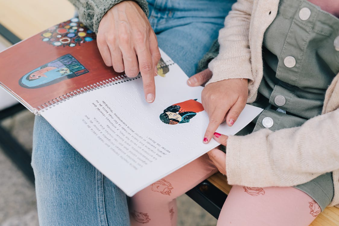 Free Mother and Daughter Reading a Story in Braille Stock Photo
