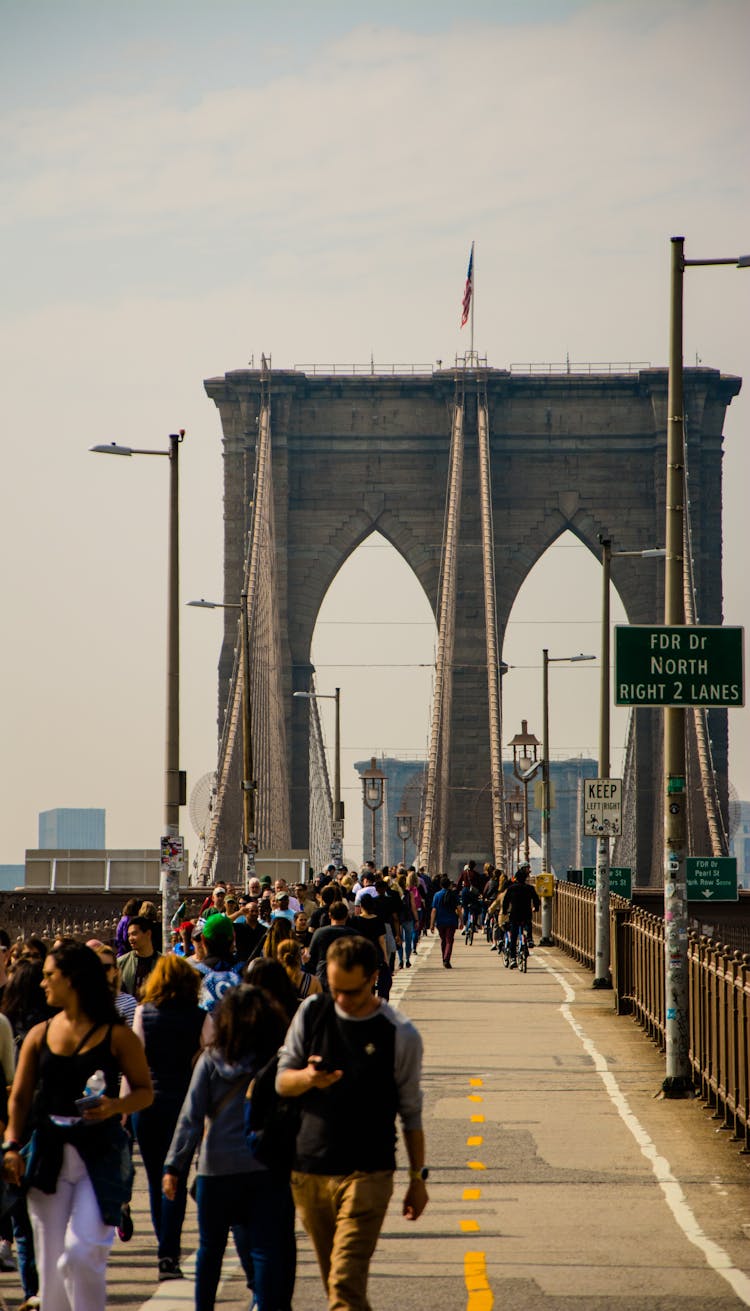 People Crossing The Brooklyn Bridge