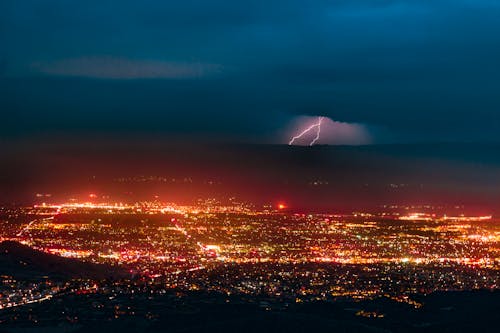 Aerial Photography of Urban City Overlooking Lightning during Nighttime