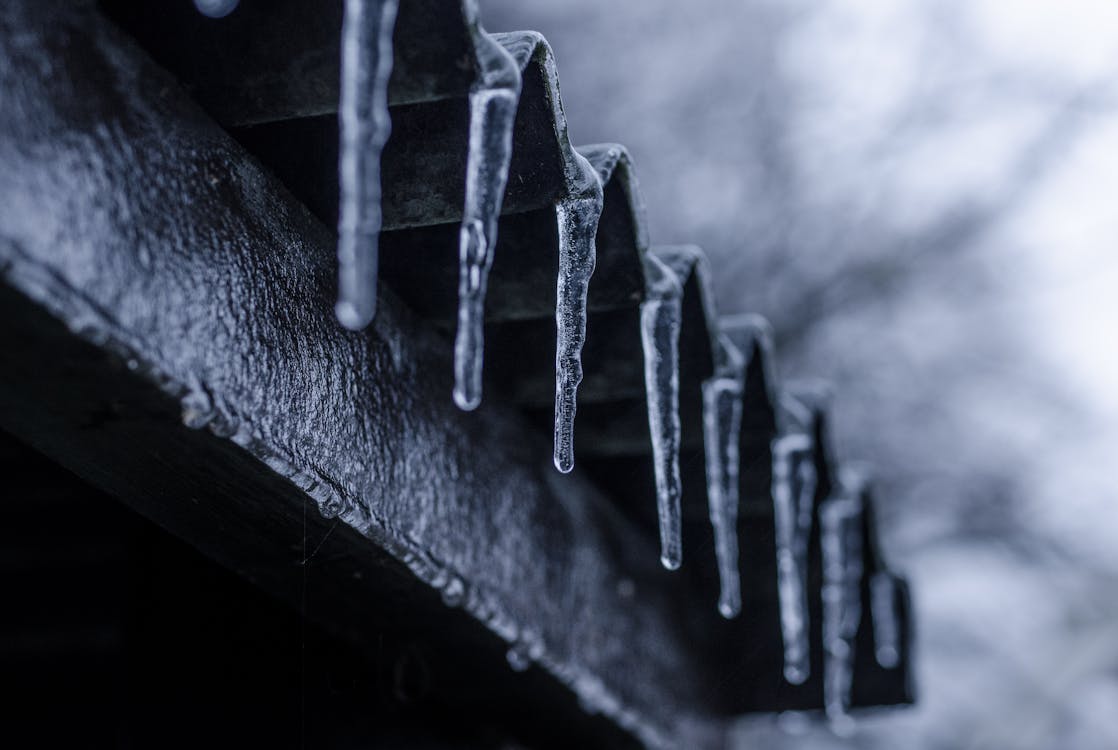 Close-up Photography of Ice Crystals on Edges of Corrugated Sheets