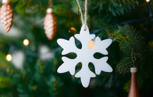 White Snow Flake Hanging on Christmas Tree