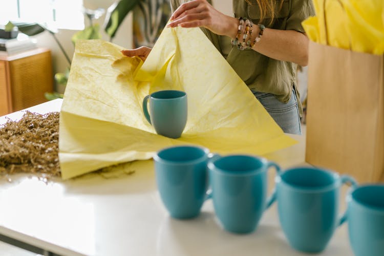 
A Woman Packing A Mug