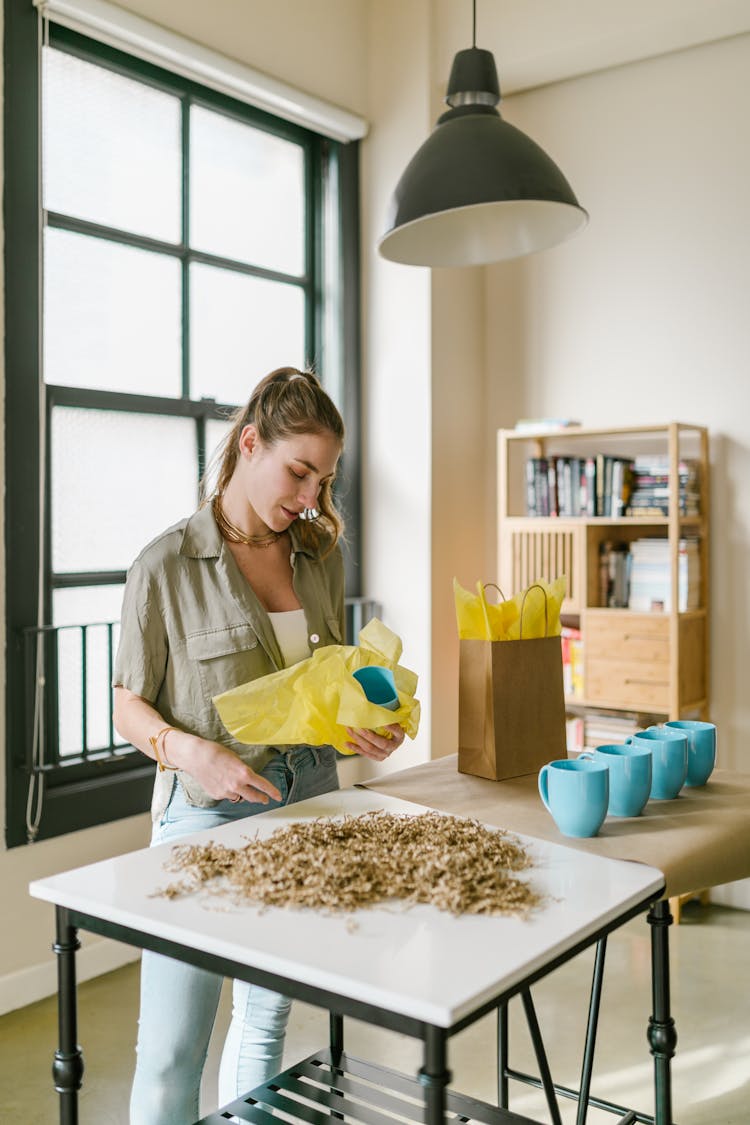 A Woman Packing A Mug