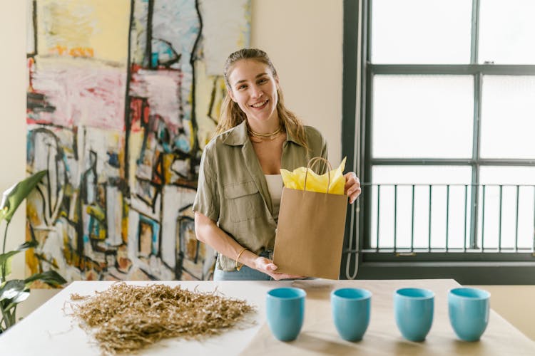 A Woman Holding A Brown Paper Bag