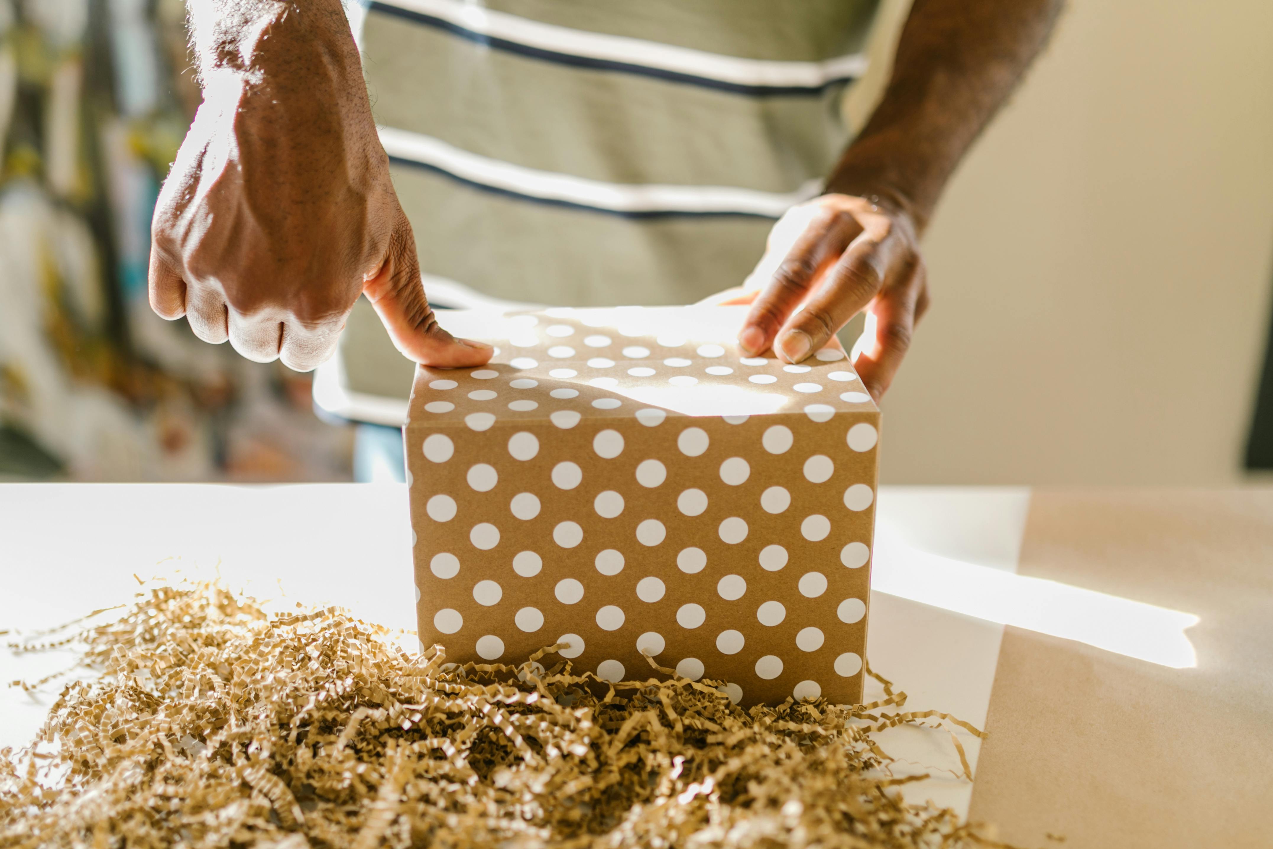 person wrapping a gift