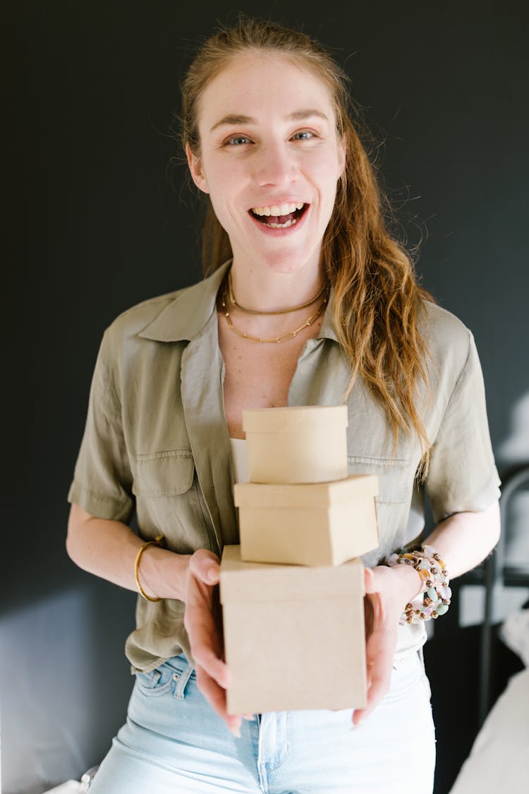 A Young Woman Holding Cardboard Boxes