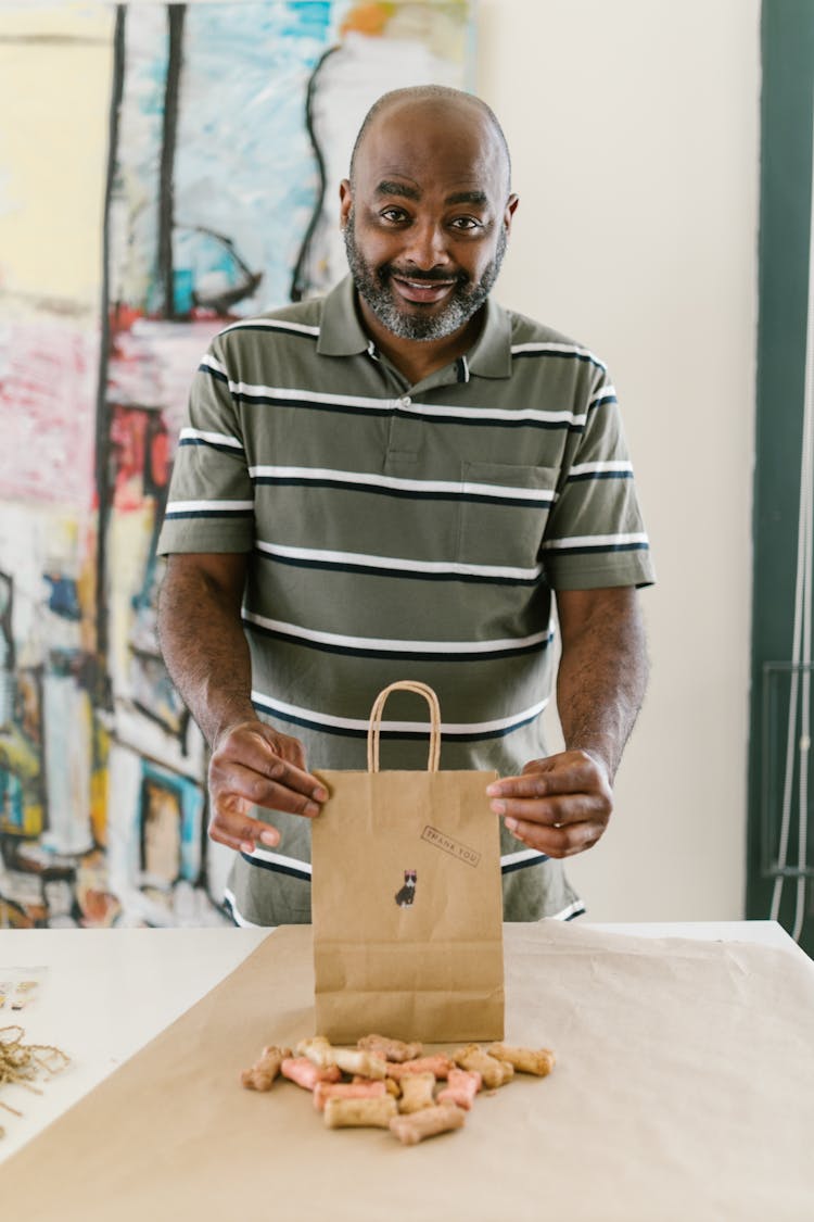 A Man Holding A Paper Bag