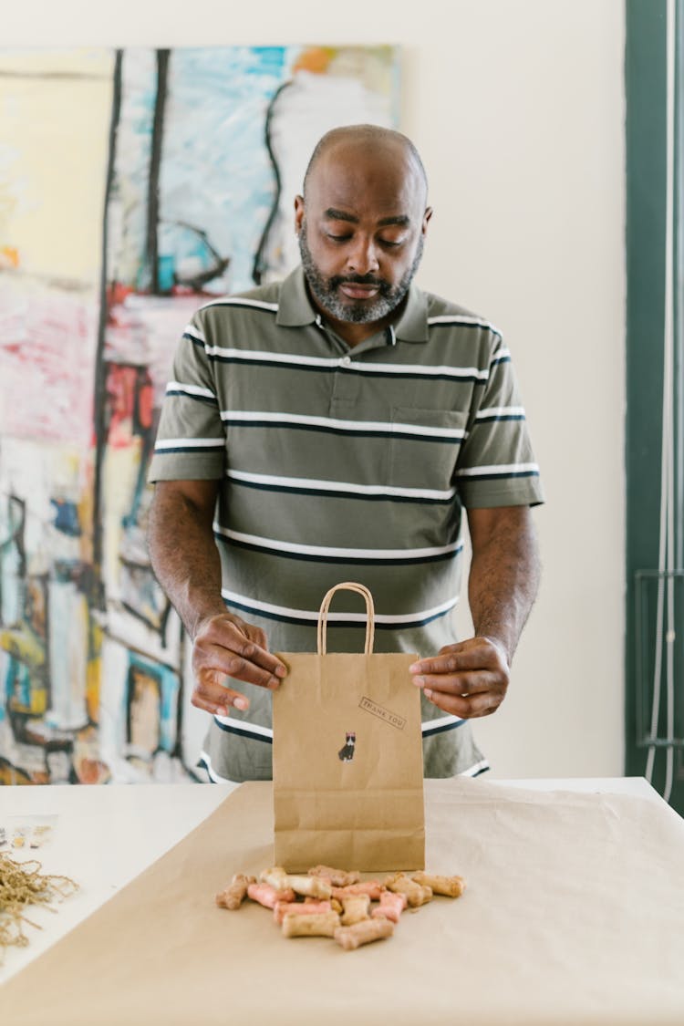 A Man Holding A Paper Bag