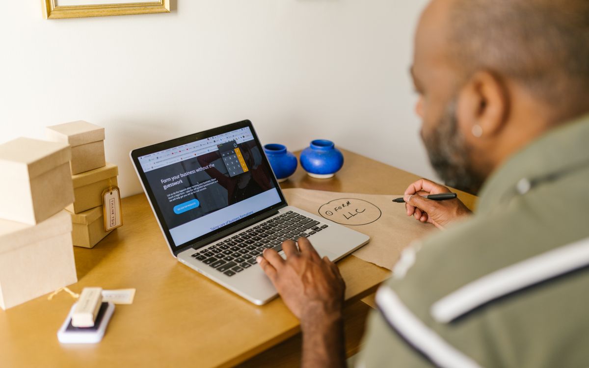 Entrepreneur at a desk using a laptop for business planning. Ideal for tech and startup themes.