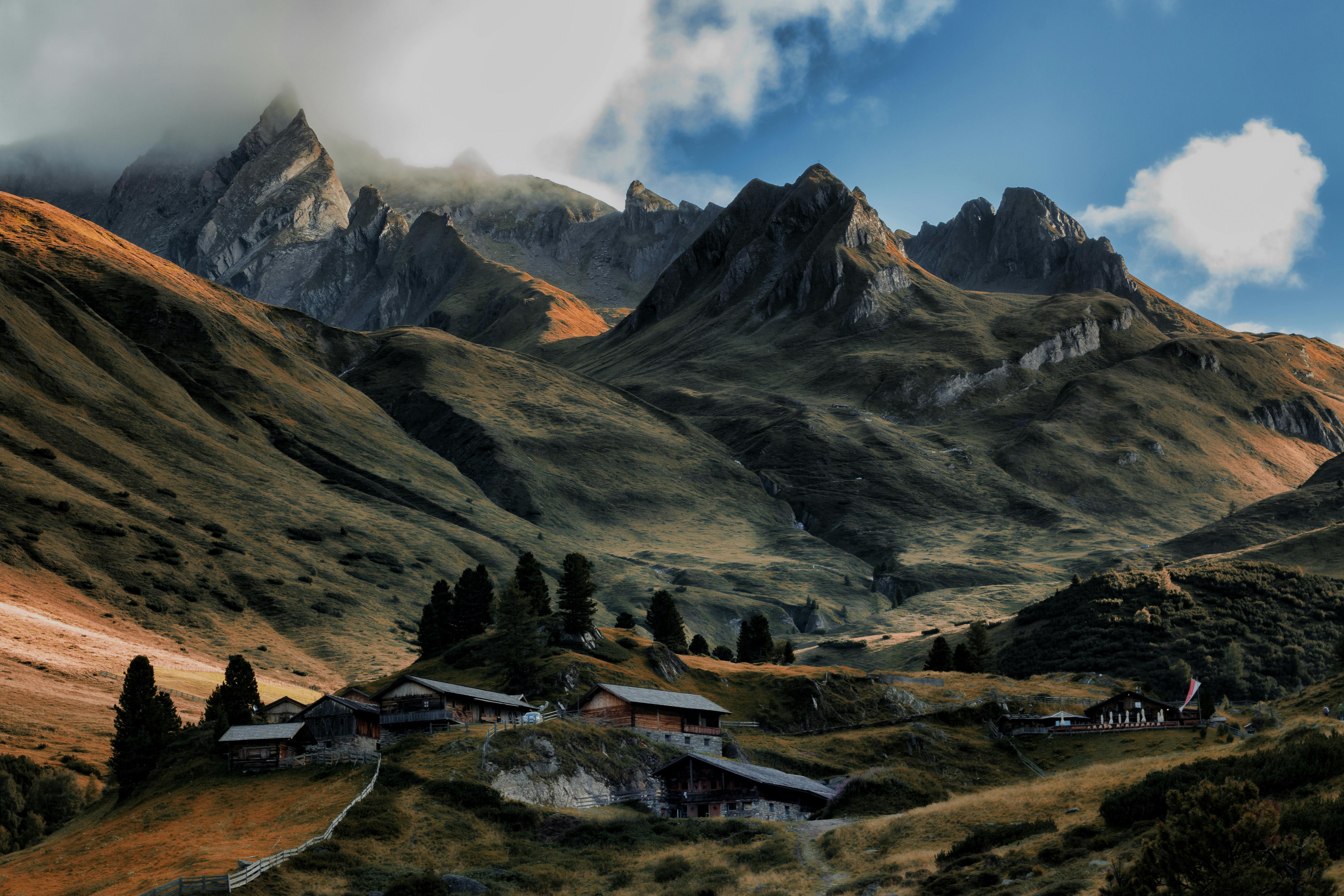 brown house in between of mountains