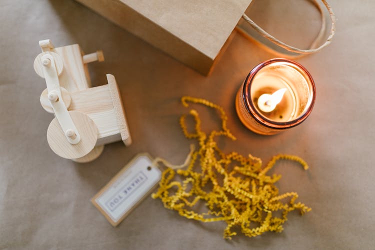 Wooden Toy And A Lighted Candle