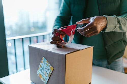 Free A Person Packing a Box Stock Photo