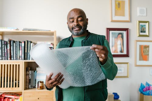 Close-Up Shot of a Man Holding Bubble Wrap