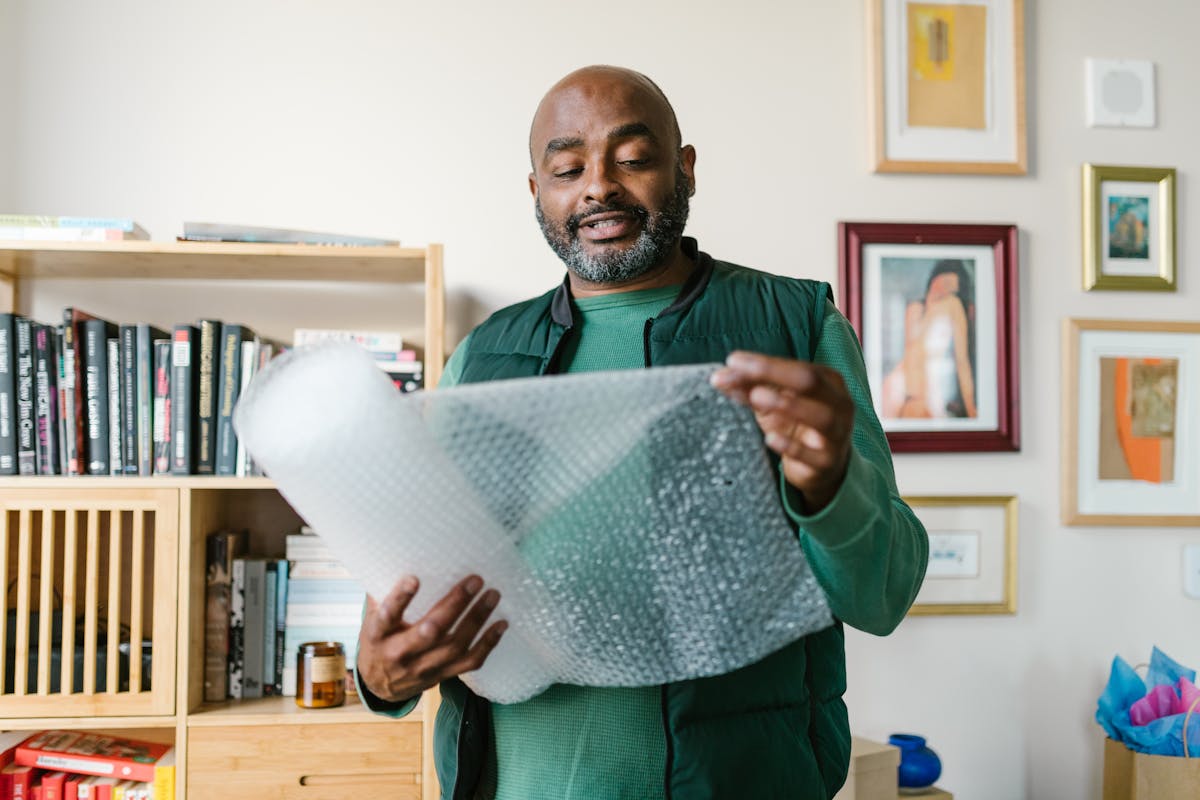 Hands arranging food on a wooden board with small bowls and a knife in the background