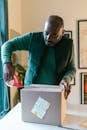 A Man Packing a Cardboard Box with a Thank you Card