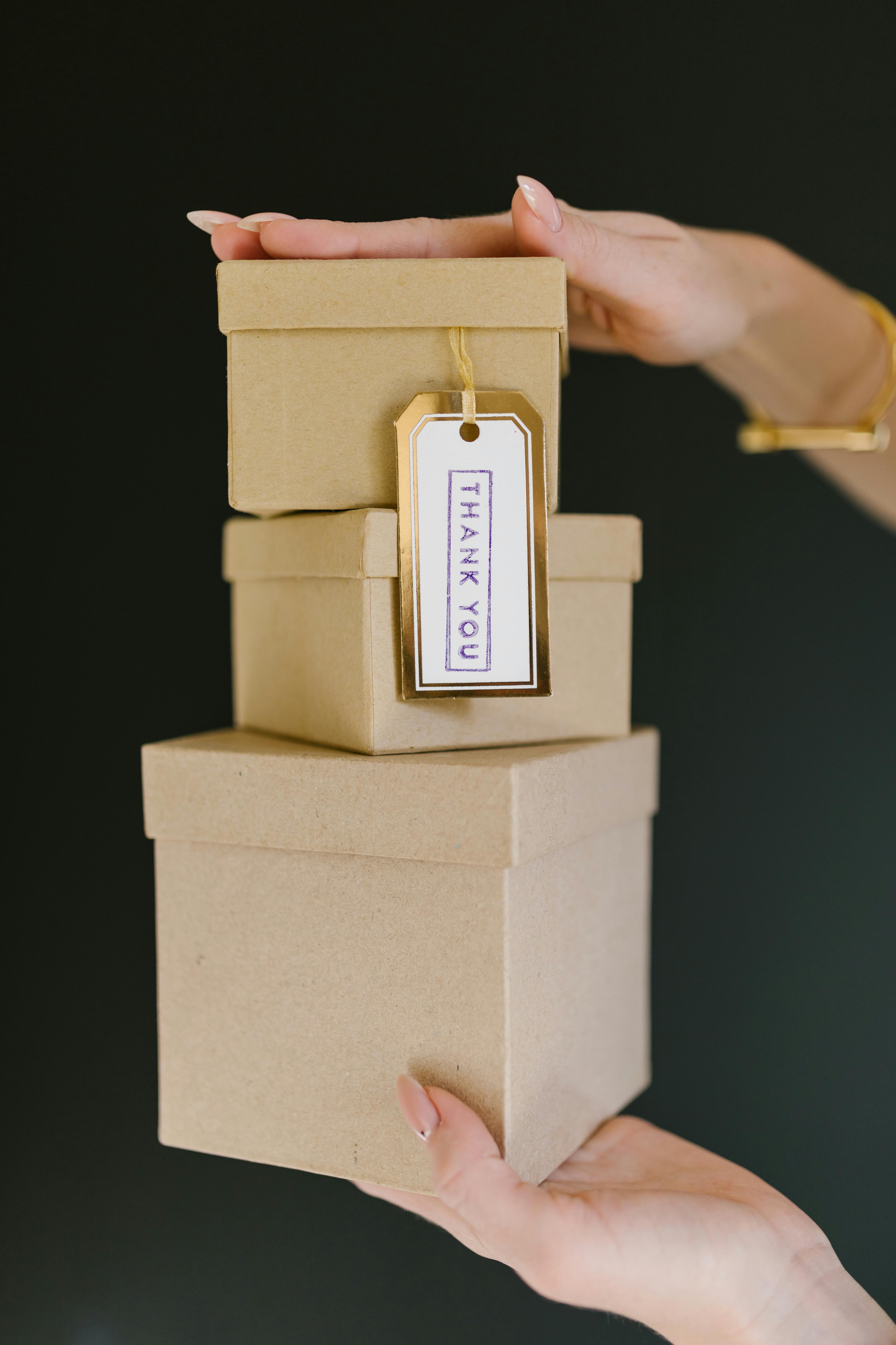 person holding brown wooden box