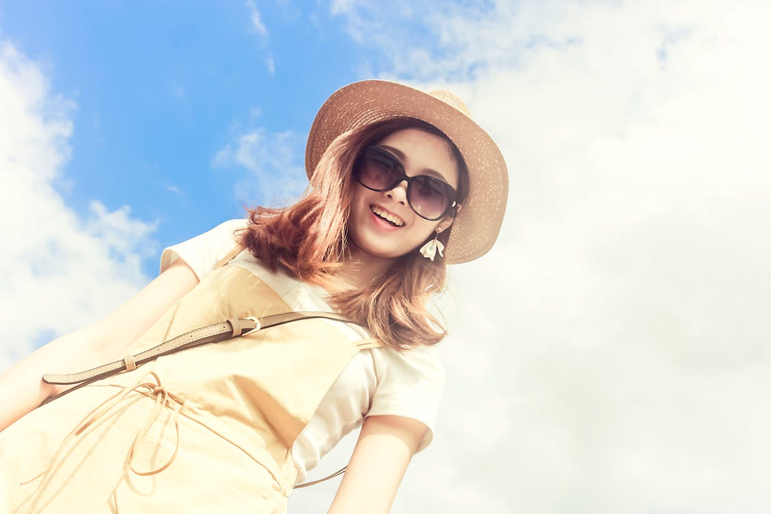 Free Woman Wearing Dress Smiling Taking for Picture Under Cloudy Skies Stock Photo