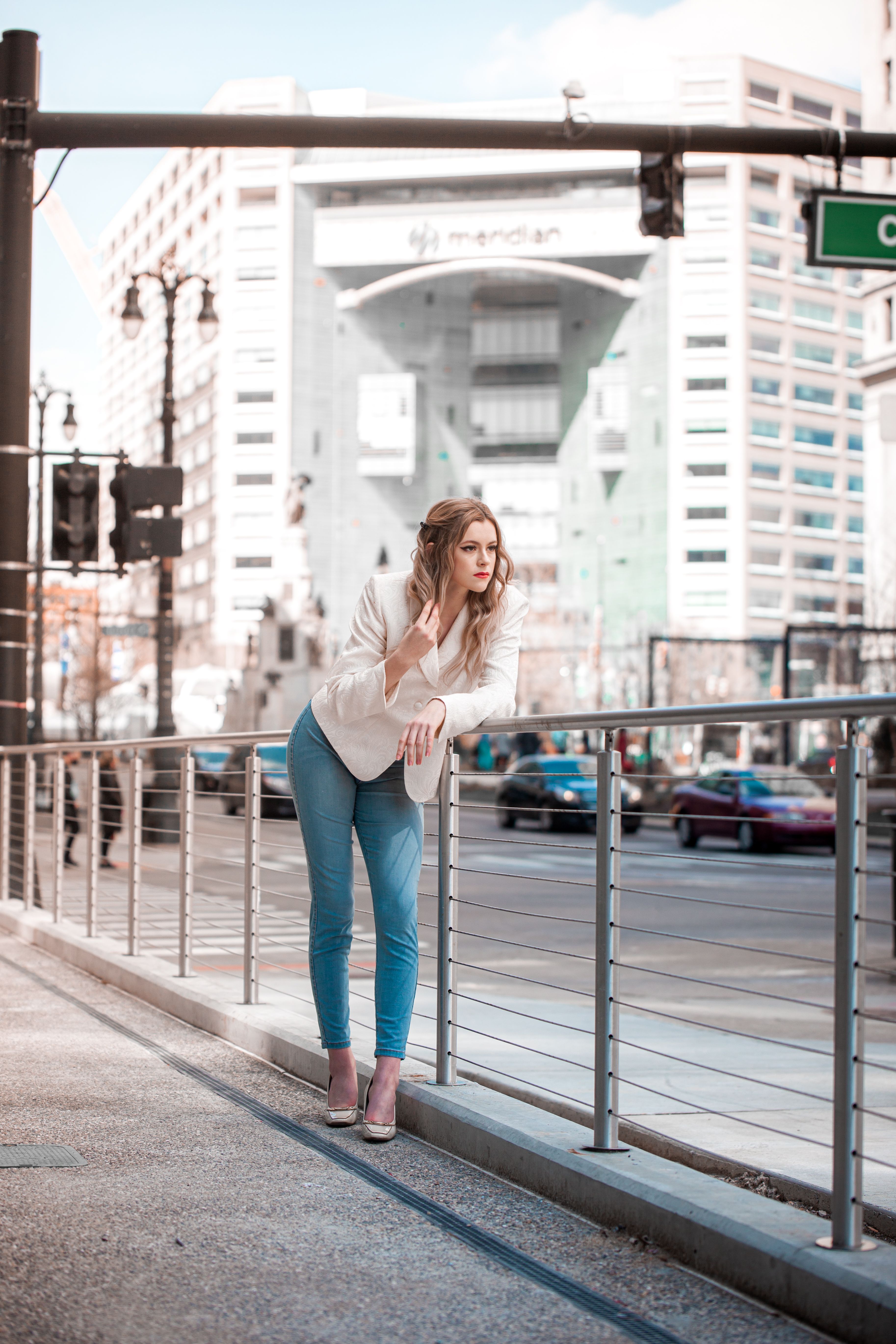 A Woman Leaning by the Metal Railings on the Street · Free Stock Photo