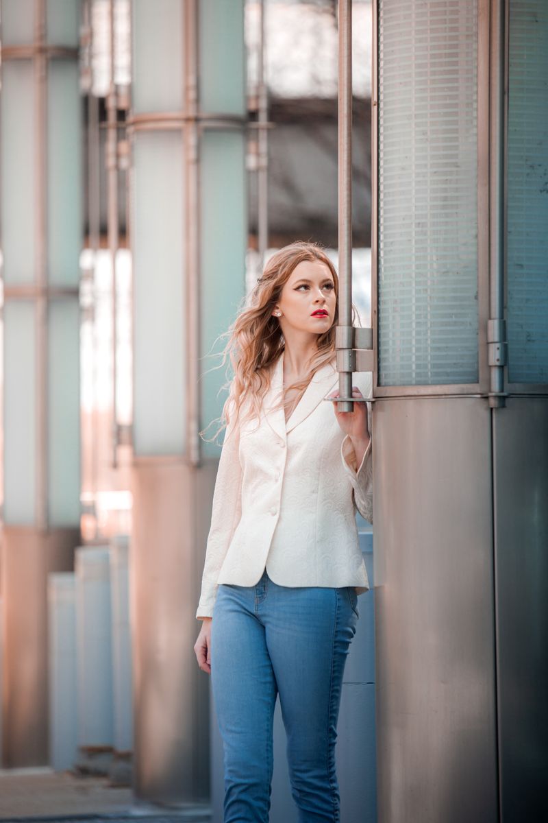 Woman in white blazer and blue jeans, professional chic outfit