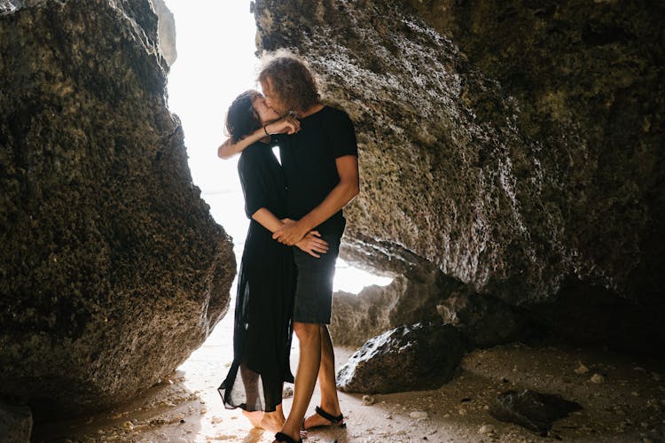 A Romantic Couple Kissing On The Beach