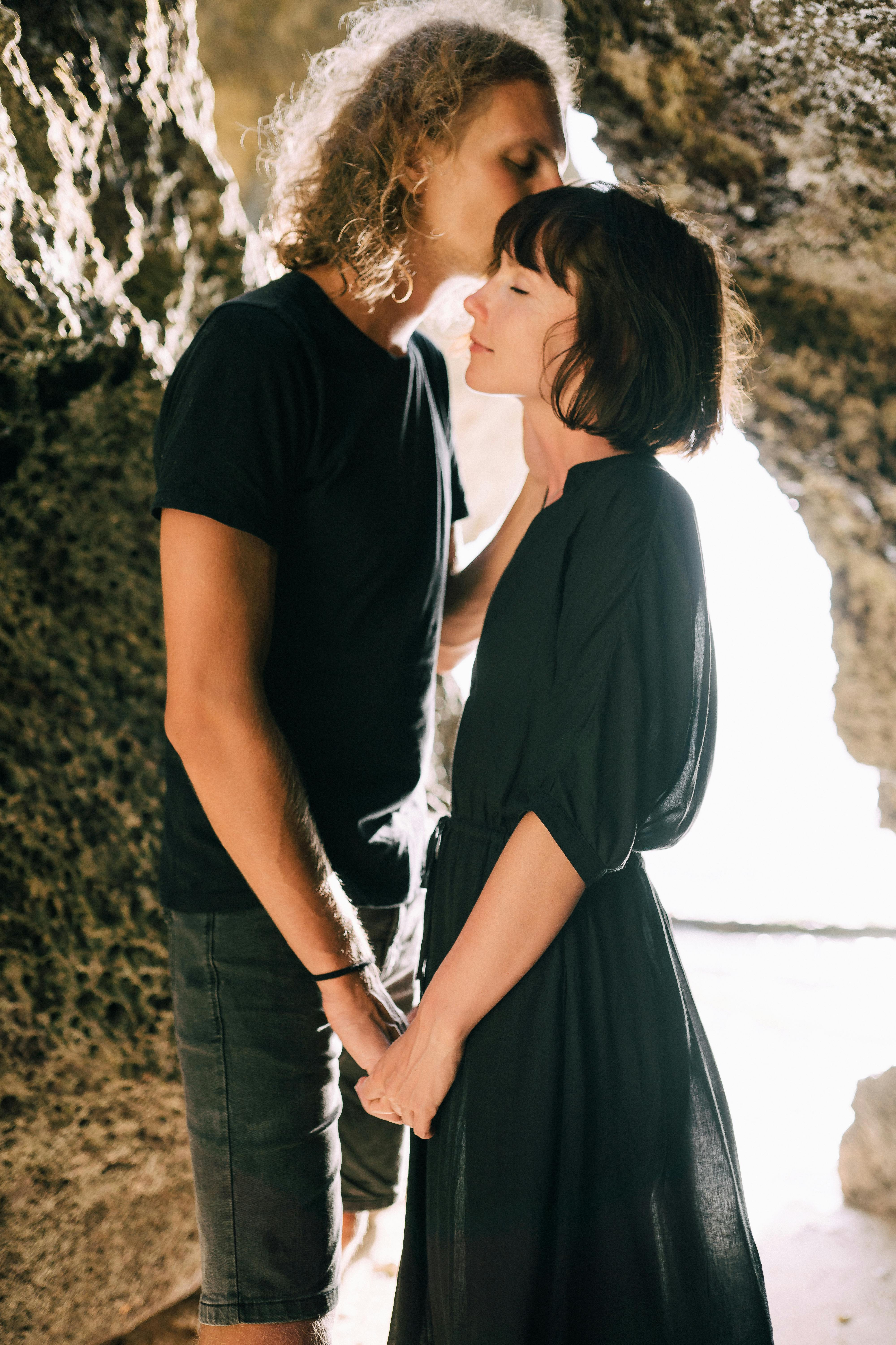 A Couple Holding Hands and Kissing · Free Stock Photo