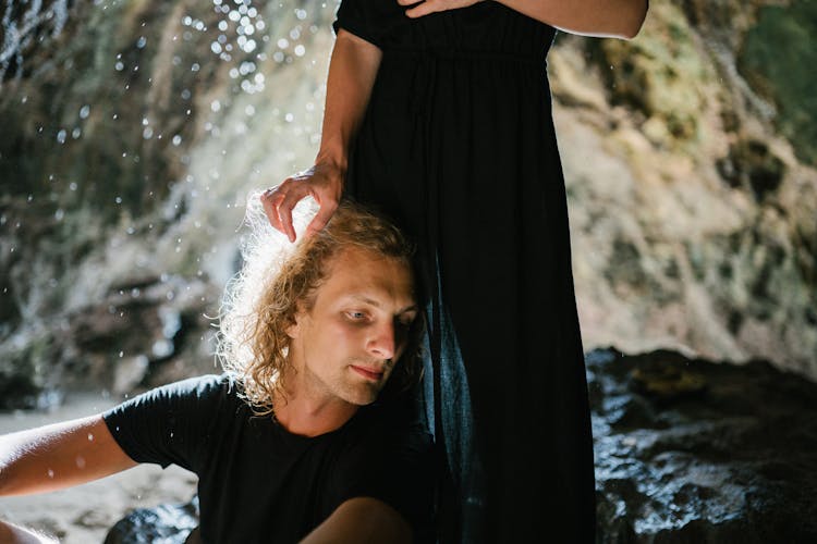 Man Leaning On Woman's Legs