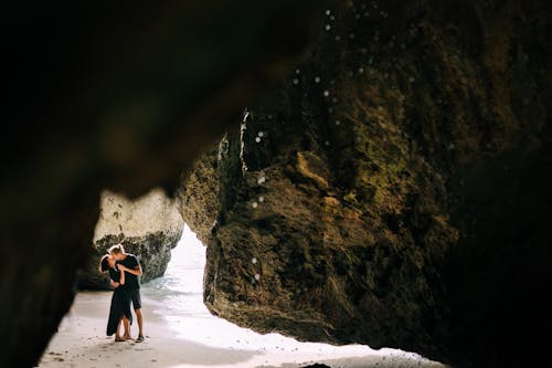 A Sweet Couple Kissing Each Other while Standing in a Cave