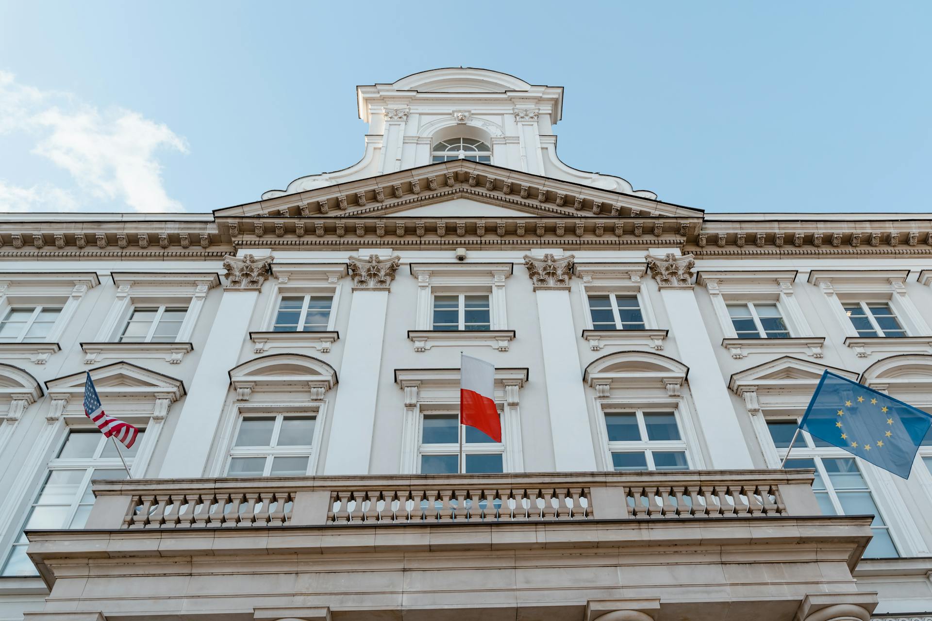 Old Building With Flags Hanging On Balcony