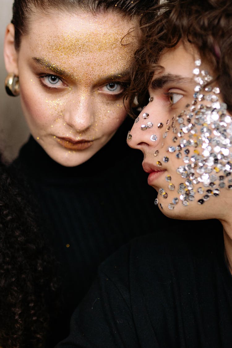 A Man And A Woman With Sequins And Glitters On Their Faces