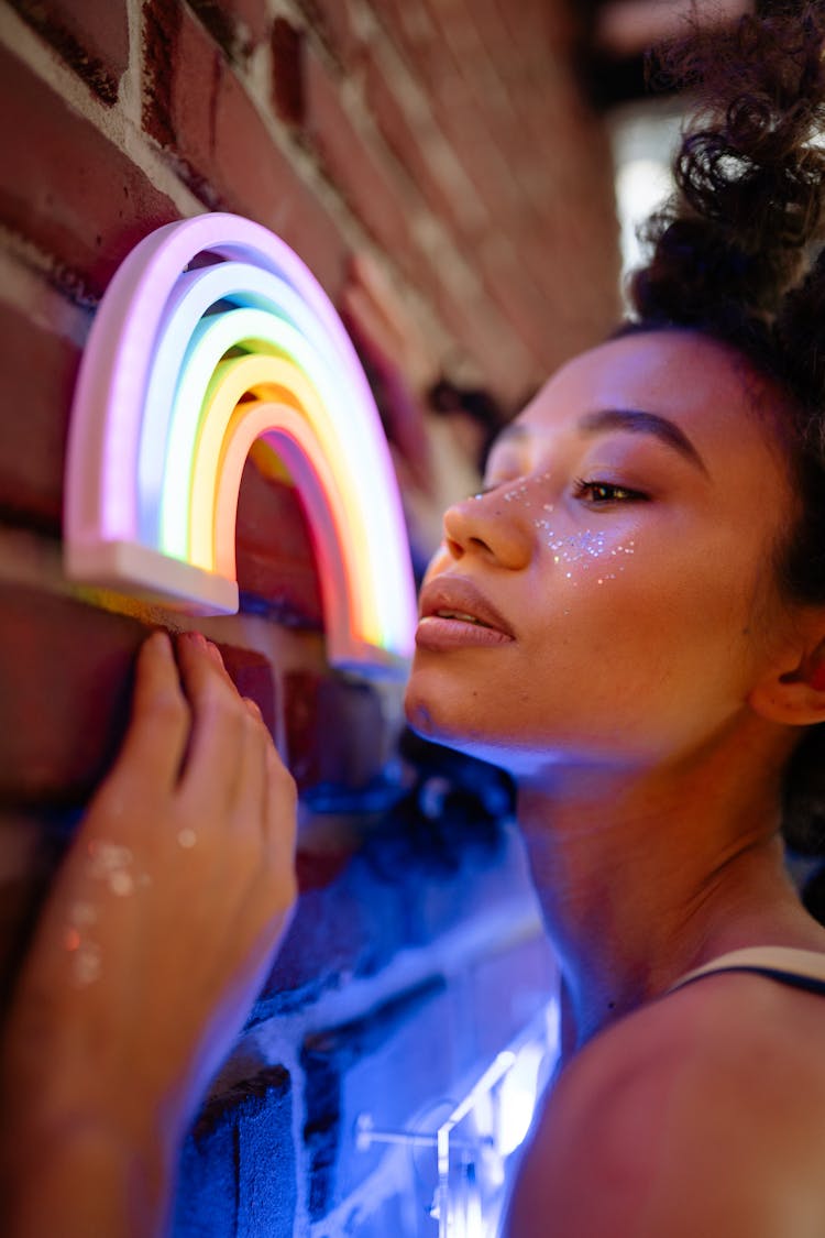 A Woman's Face Near A Neon Rainbow