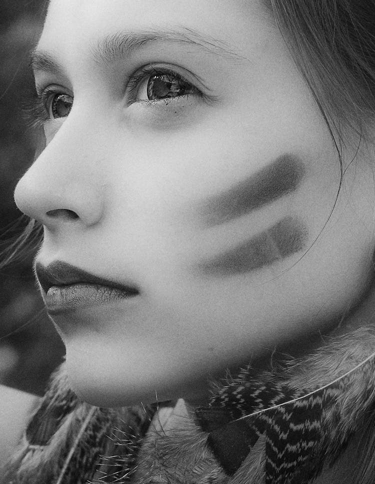 A Close-up Shot Of A Woman With Marks On Cheeks